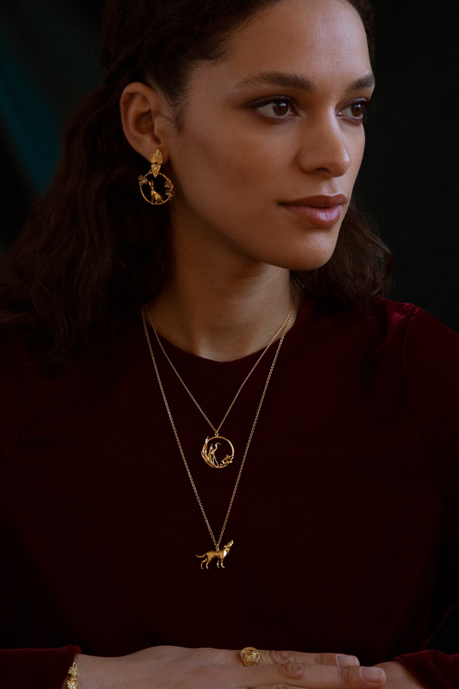 Model wears Fables Wolf and Heron necklace and Hare and Tortoise earrings