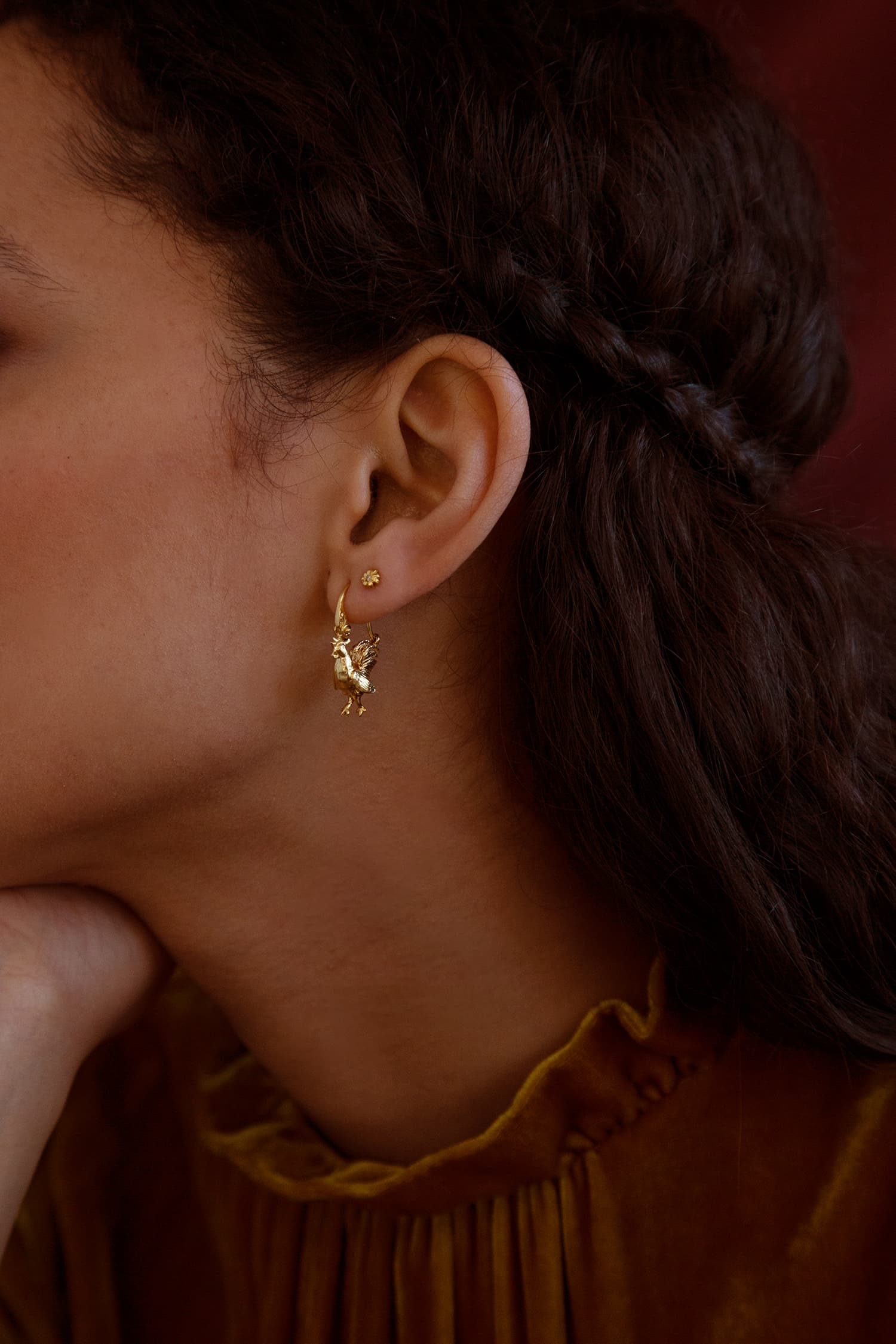 Model wears Fables small Rooster ornate Creole Earrings in gold plate