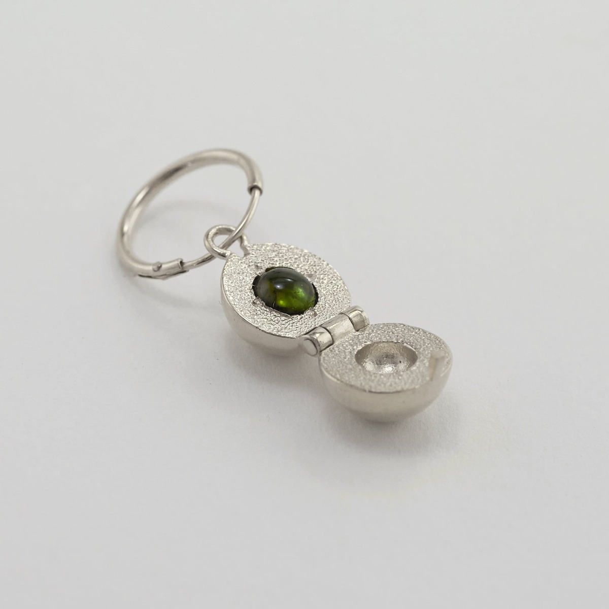 Paper shot of Cannonball Opening Earring with Hidden Green Tourmaline by Alex Monroe Jewellery