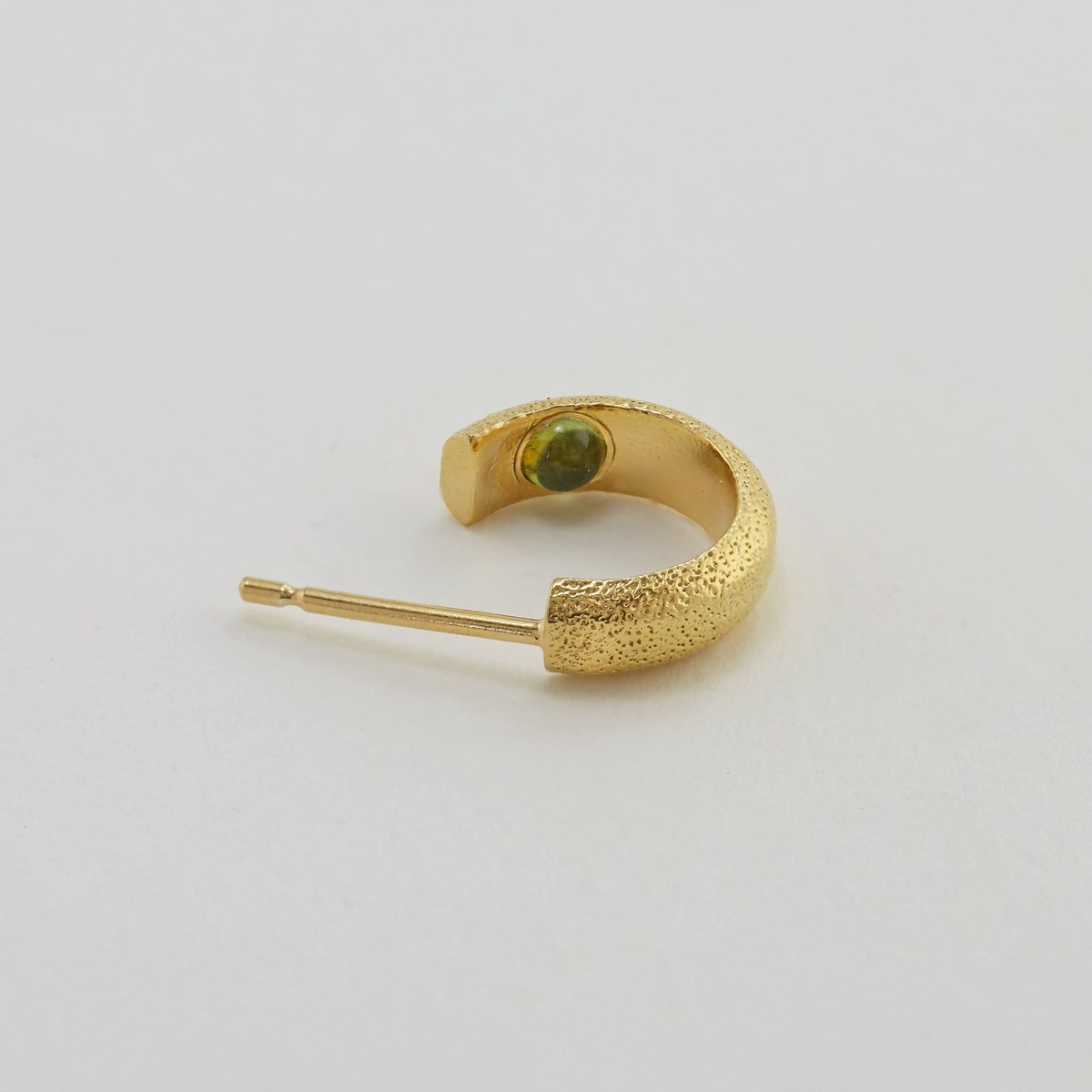 Paper shot of Hans Hoop Earring with Hidden Green Tourmaline by Alex Monroe Jewellery