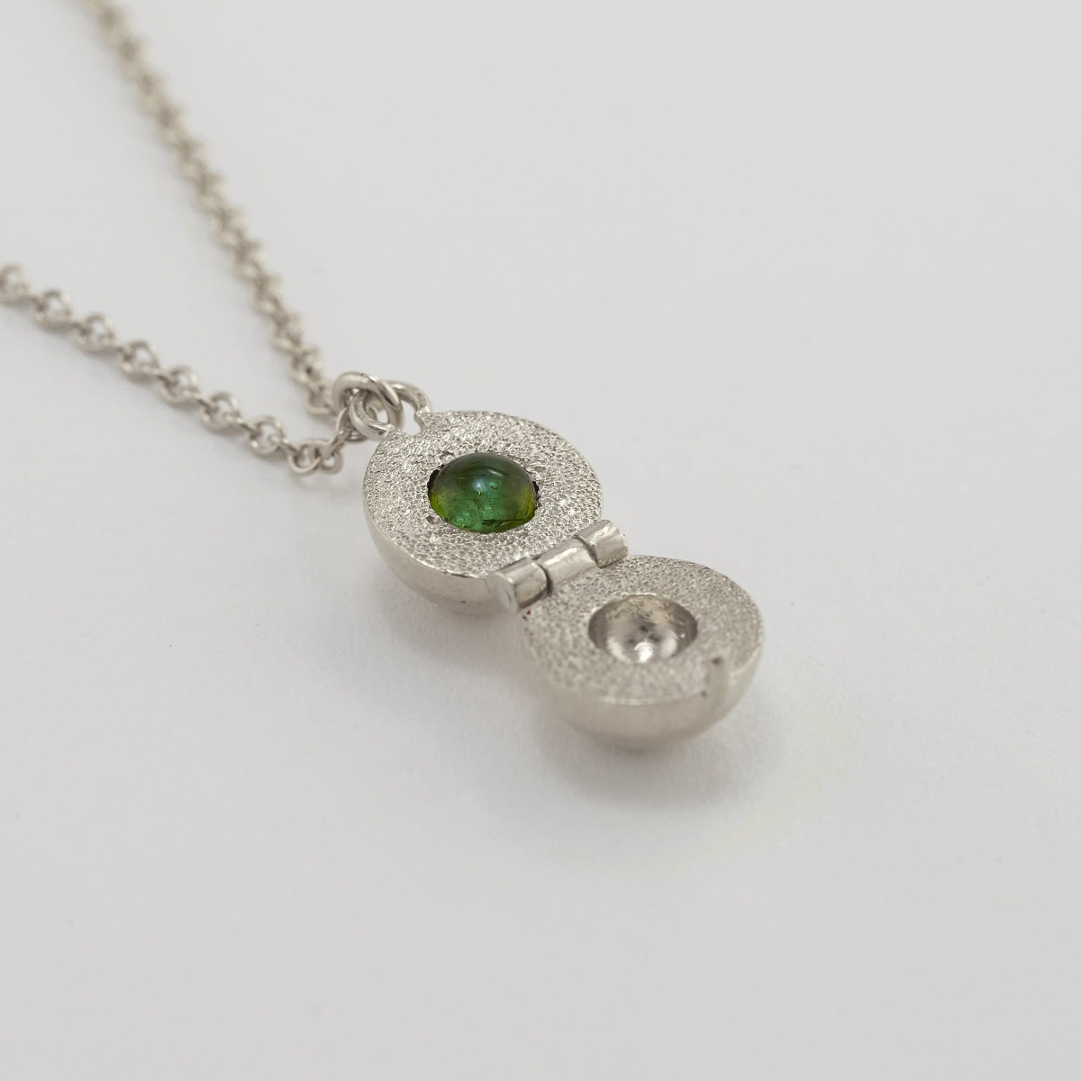 Paper shot of Cannonball Opening Necklace with Hidden Green Tourmaline by Alex Monroe Jewellery