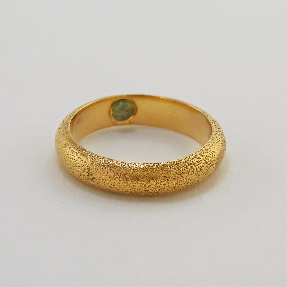 Paper shot of Hans D-Shape Hidden Green Tourmaline Ring by Alex Monroe Jewellery