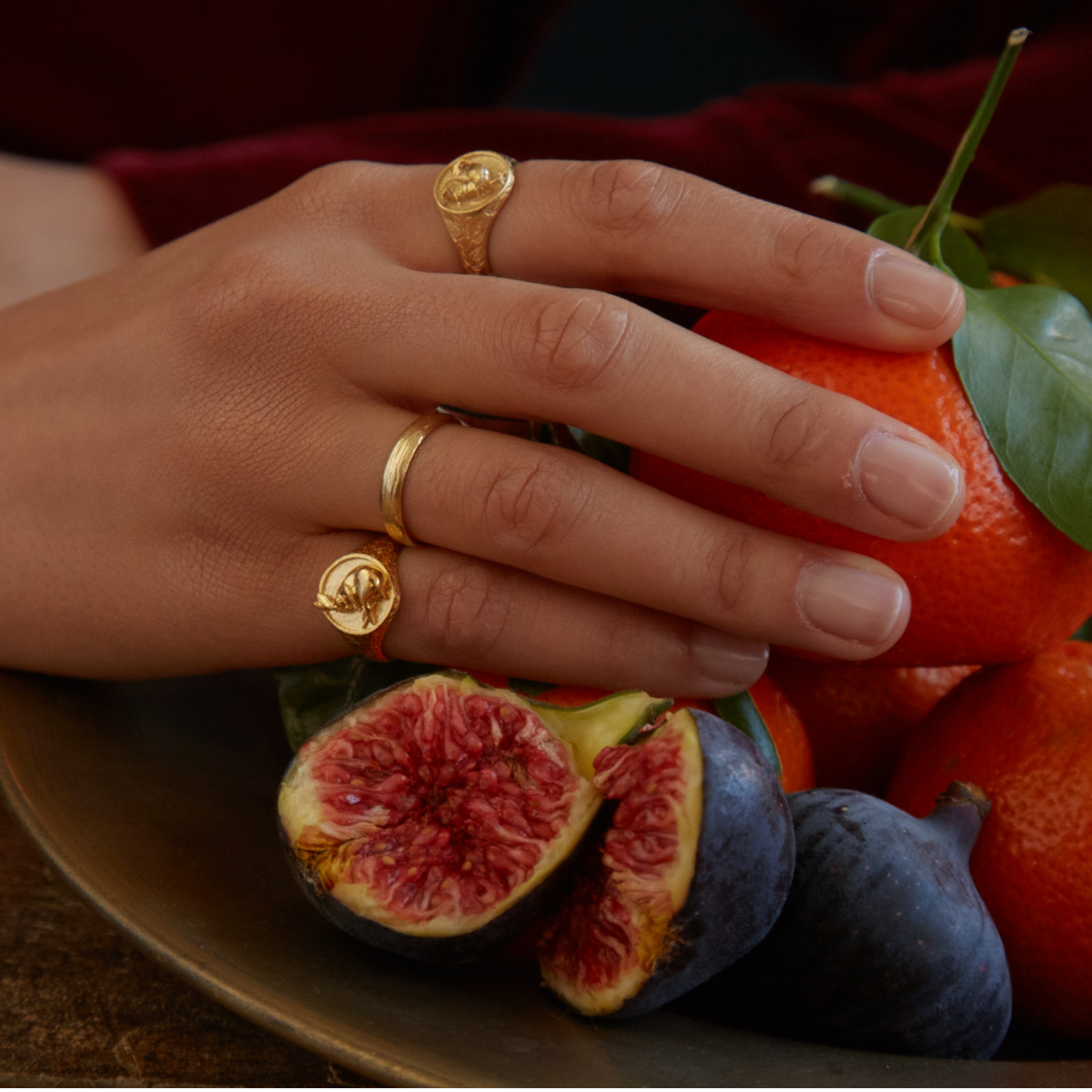 fairmined gold plated sleeping hare and rooster signet rings worn by model