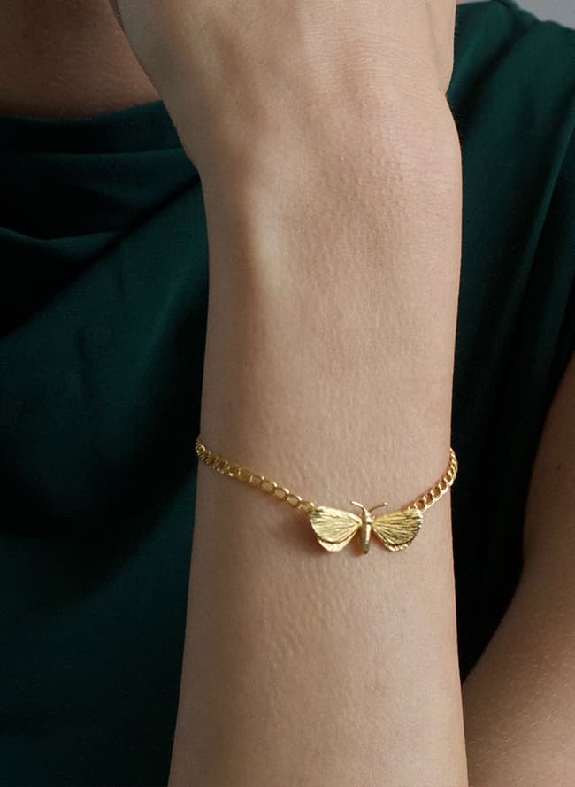 gold plated moth bracelet worn by model