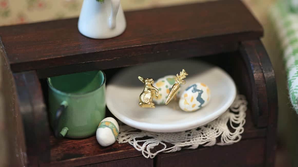 Three Mixed Metal Bee and Daisy Earrings Resting on a Vintage Green Book