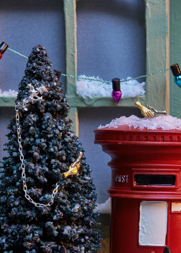 Doctor Who 13th Doctor Galaxy Ear Cuff and Stud jewellery set displayed on small christmas tree and red British postbox.