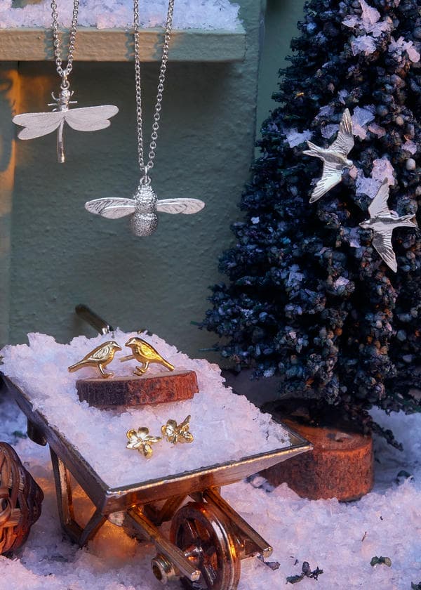 Silver Dragonfly and Baby Bee necklaces, swallow stud earrings, gold robbin studs in a tiny snow filled wheelbarrow and hung on a tiny christmas tree.