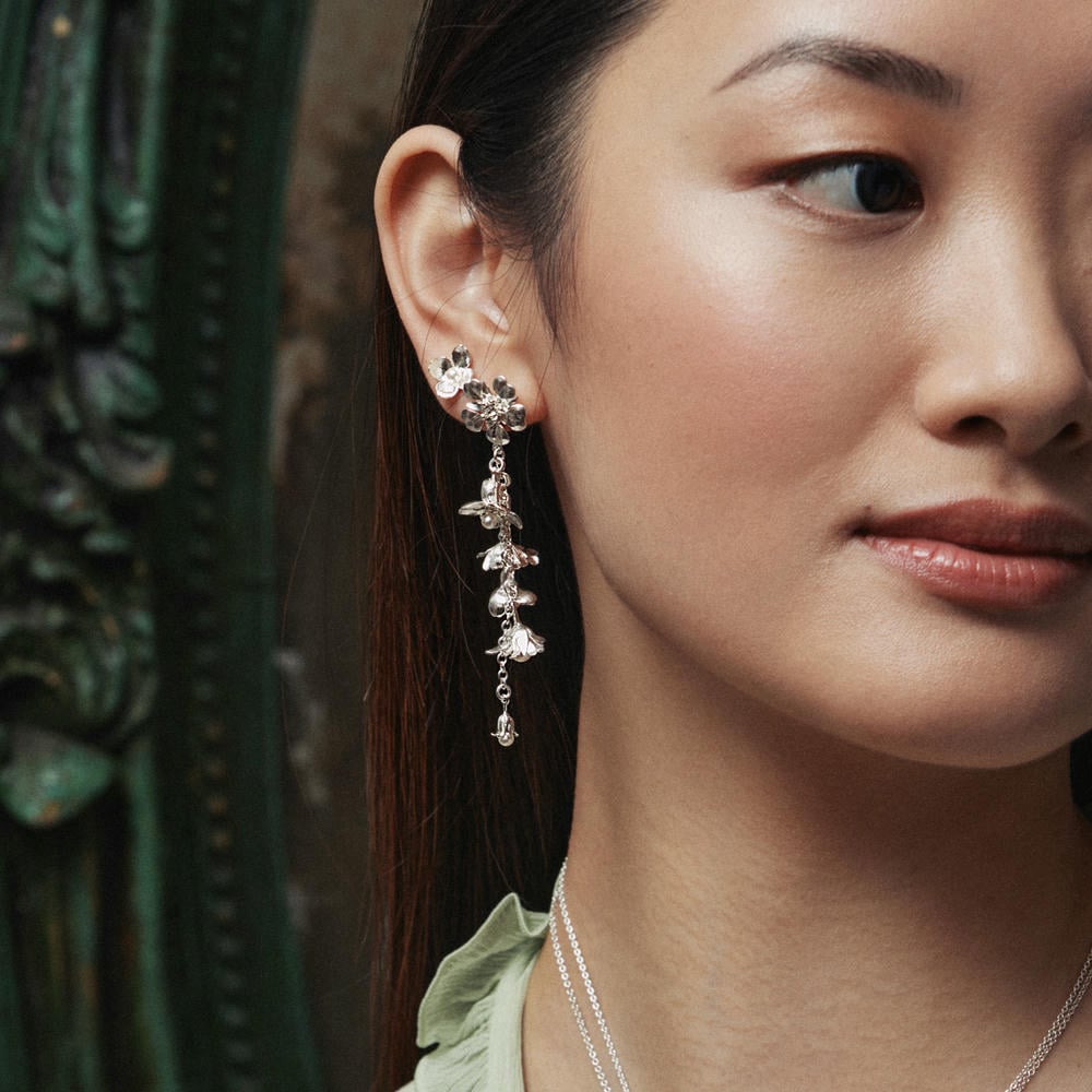 Model wearing silver Tumbling Wildflower Pearl Drop Earrings