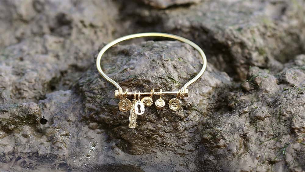 In-line bracelets displayed on festive baubles.