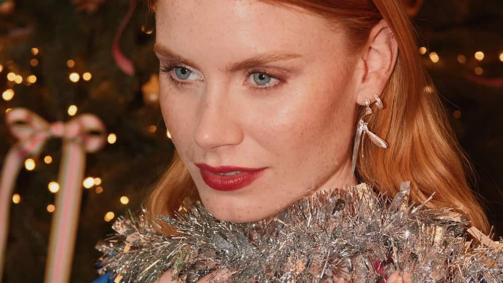 woman wearing damselfly earrings with tinsel