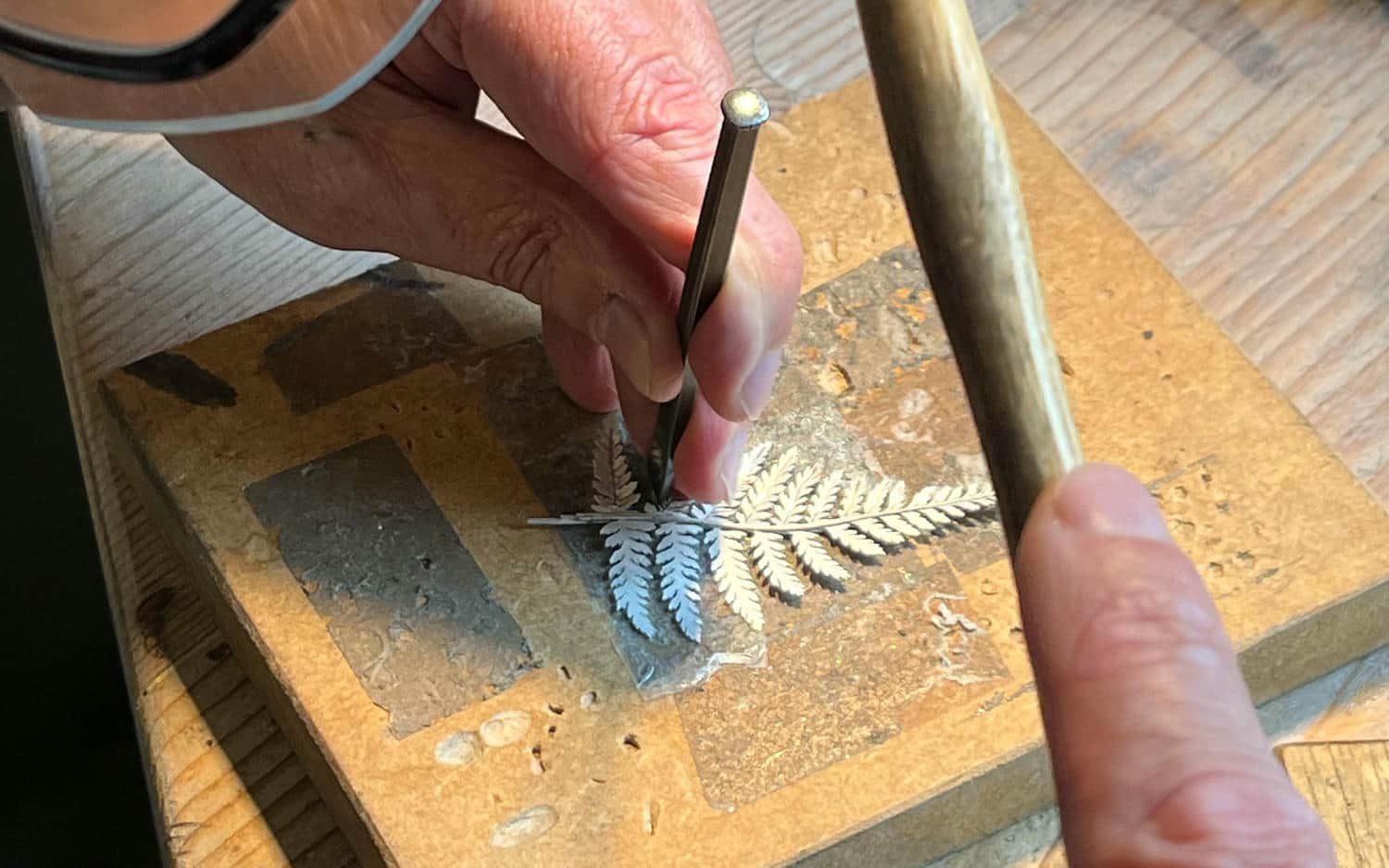 A silver fern leaf having the three dimensional texture of the leaf added via chasing the silver.