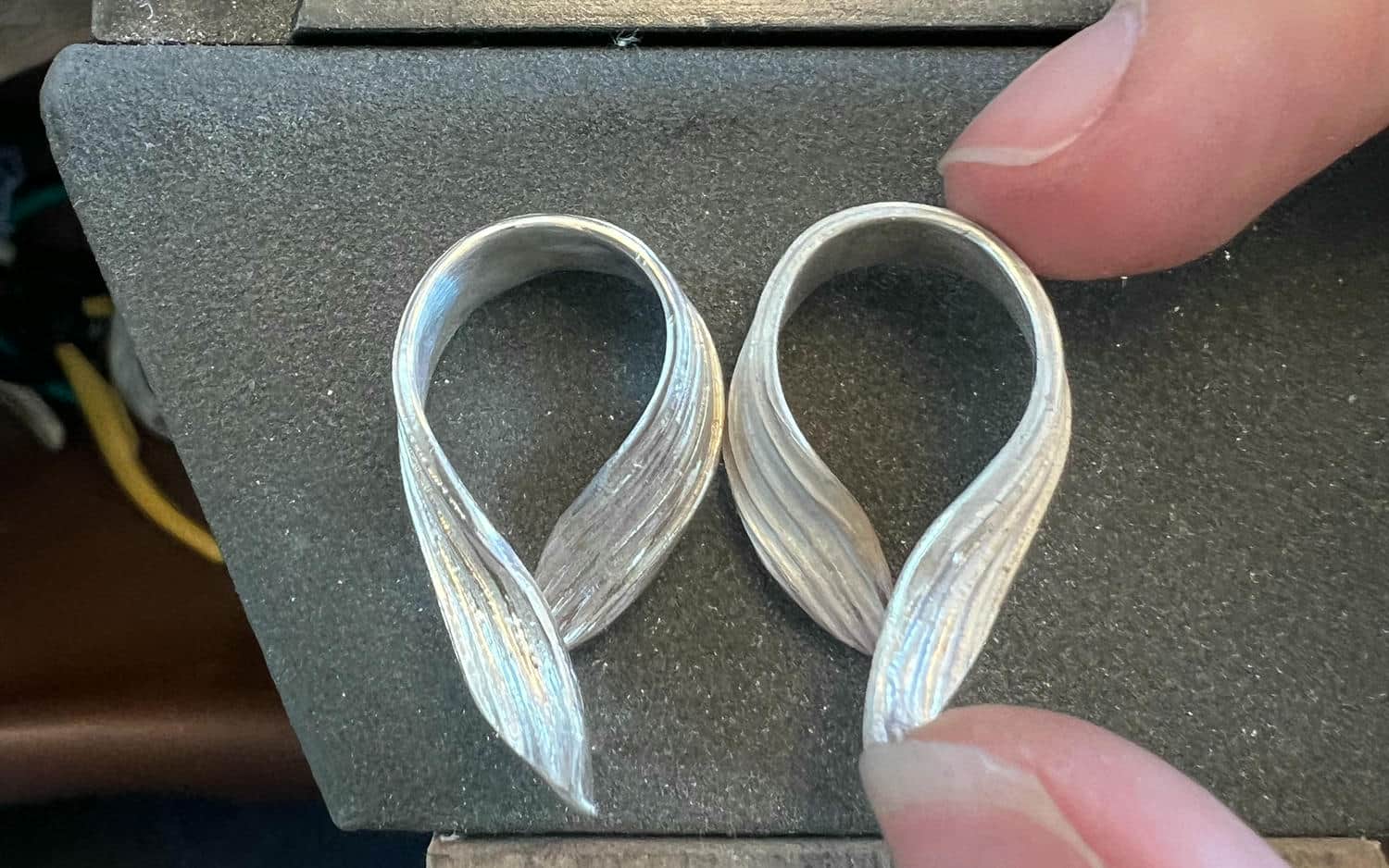 Silver curved plantain earrings.