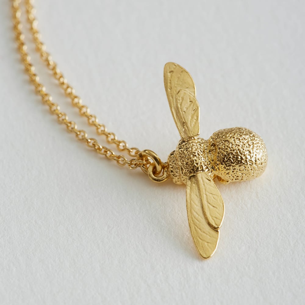 paper shot of gold plated Baby Bee Necklace by Alex Monroe Jewellery