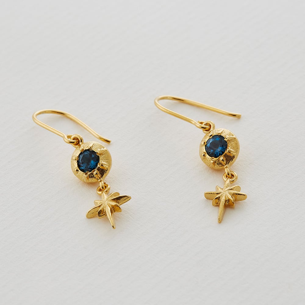 Paper shot of Guiding Star Blue Topaz Hook Earrings by Alex Monroe Jewellery