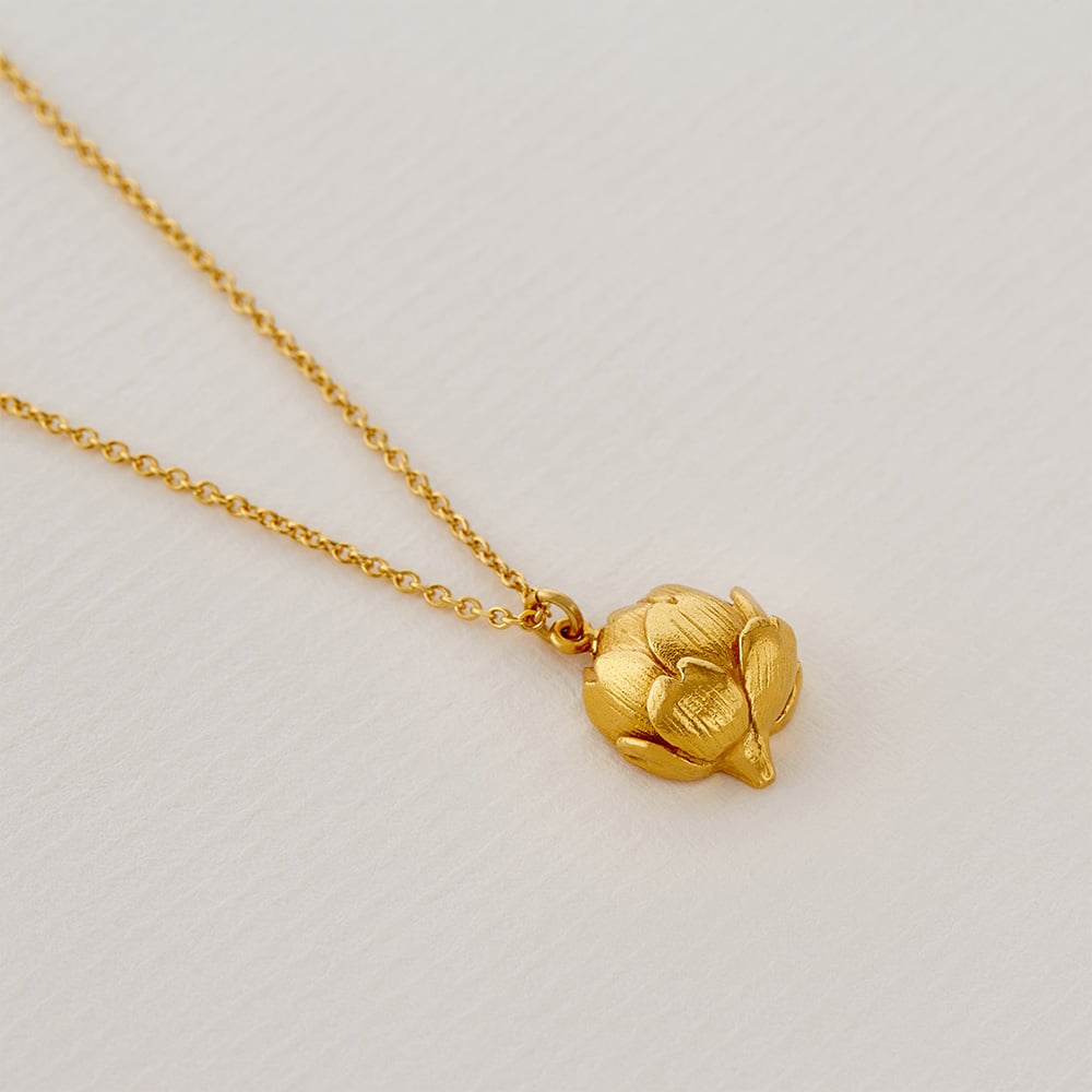 Paper shot of gold plated Artichoke Necklace with Engraved Heart by Alex Monroe