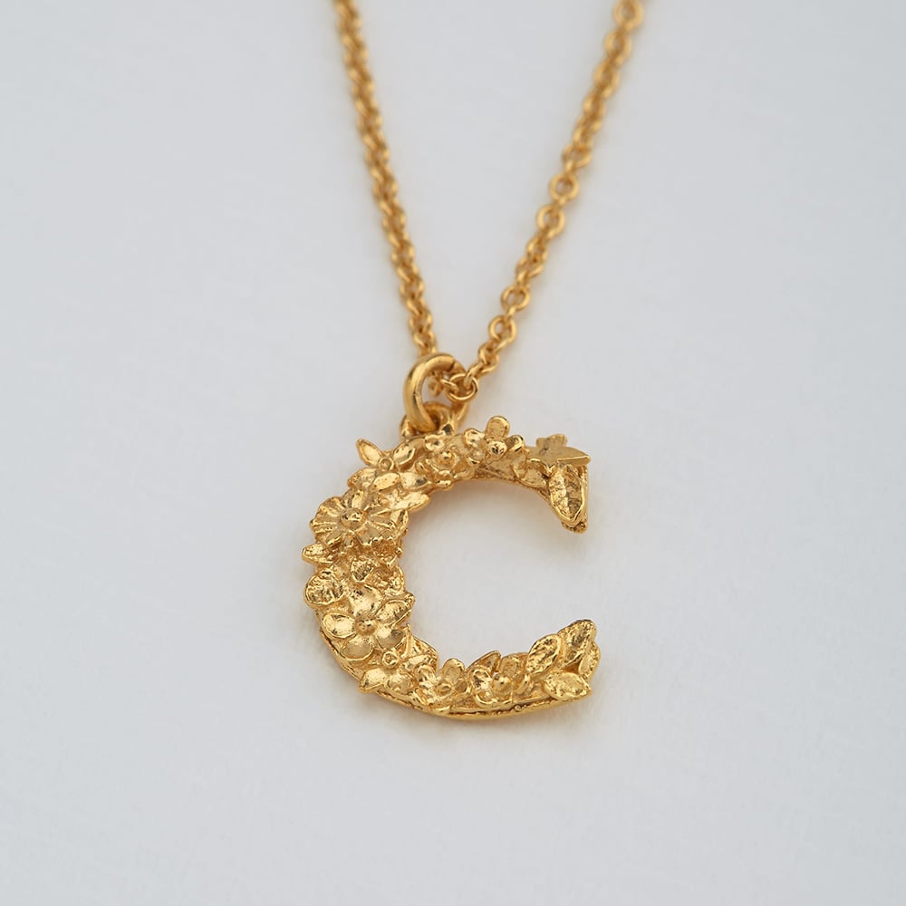 Paper shot of gold plated Floral Letter C necklace by Alex Monroe Jewellery