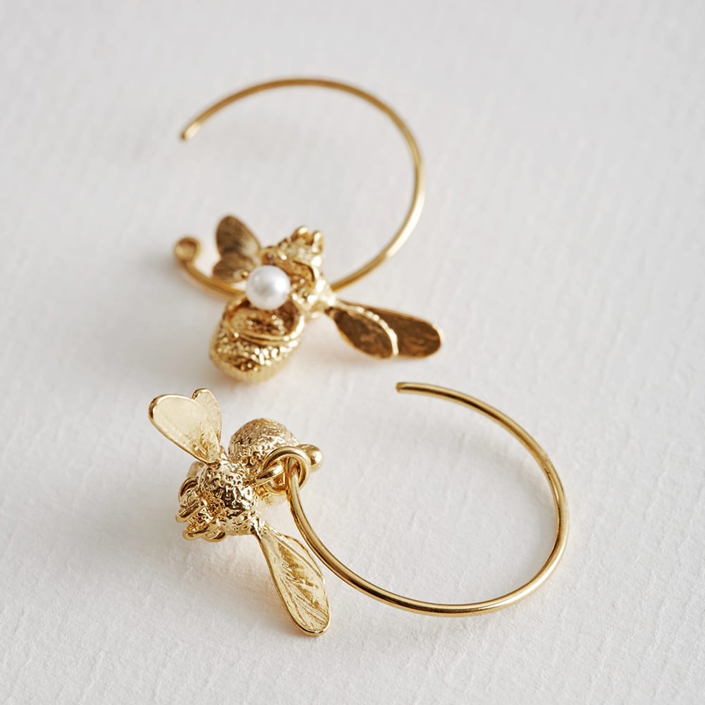 paper shot of gold plated Flying Bee with Pearl Hoop Earrings by Alex Monroe Jewellery
