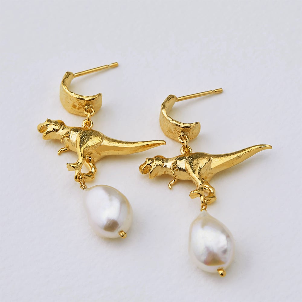 Paper shot of Gold Plated Tyrannosaurus Rex and Baroque Pearl Drop Earrings by Alex Monroe Jewellery