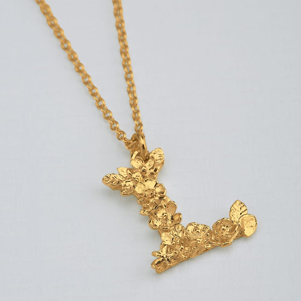 Paper shot of gold plated Floral Letter L Necklace