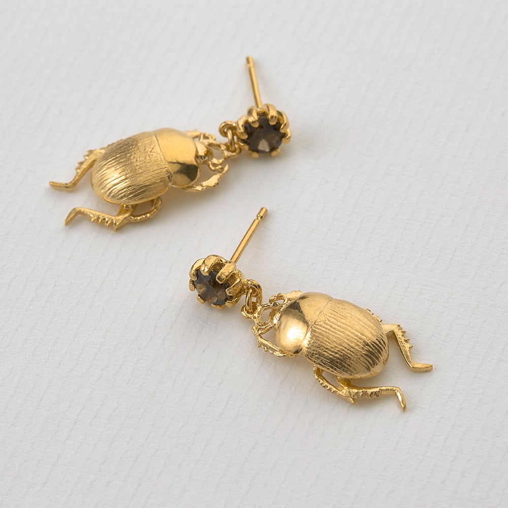 Paper shot of gold plated Dor Beetle & Smoky Quartz Drop Earrings