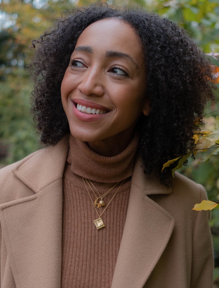 Hazel Gardiner wear gold plated Artichoke Necklace and Seed Packet Necklace by Alex Monroe Jewellery