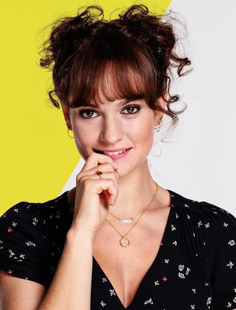 Lily James wearing mixed metal Marching Elephants Necklace and Baby Posy Loop Necklace by Alex Monroe jewellery