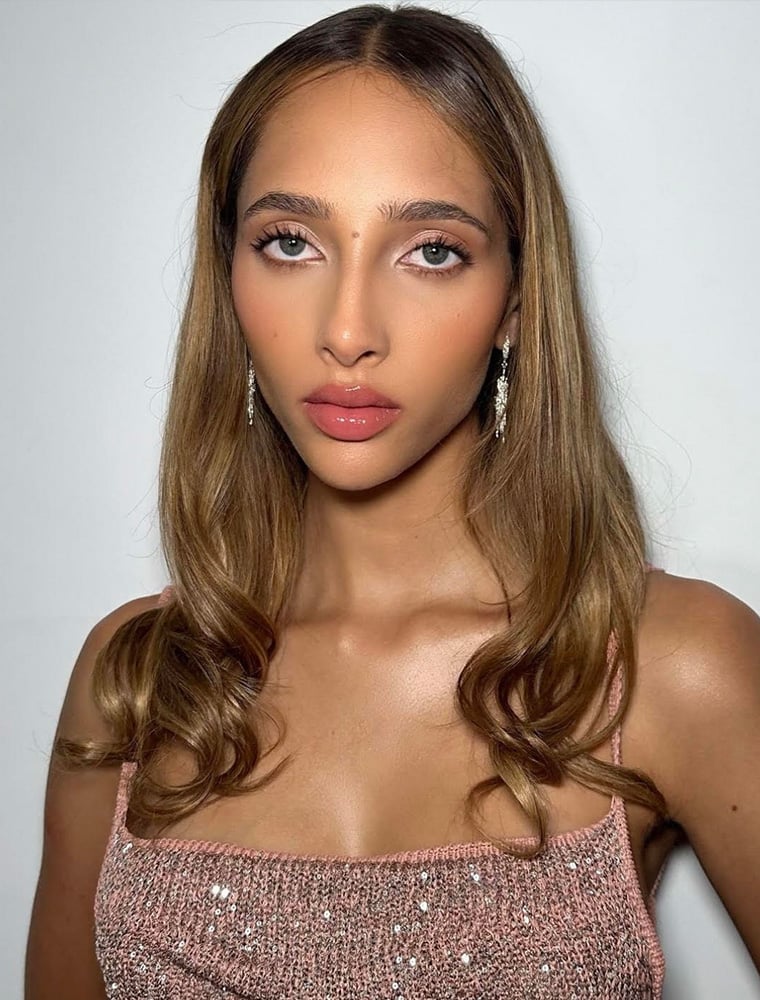 Yasmin wijnaldum wears Nest Structure Statement Drop Earrings by Alex Monroe Jewellery