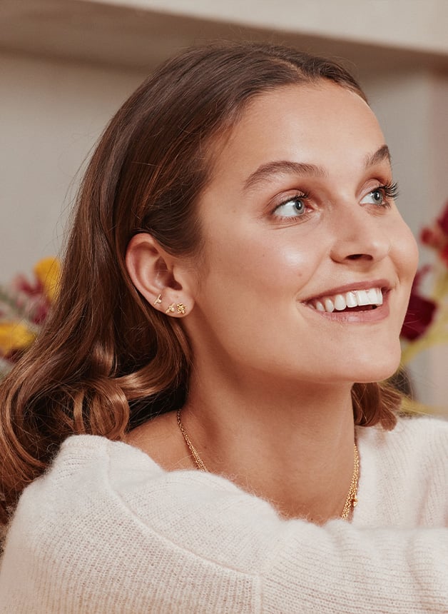 Model wearing Forget Me Not Stud Earrings with Itsy Bitsy Bee from Alex Monroe's A garden gathering Collection