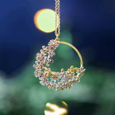 Posy Bloom Loop Necklace on a green and blue background