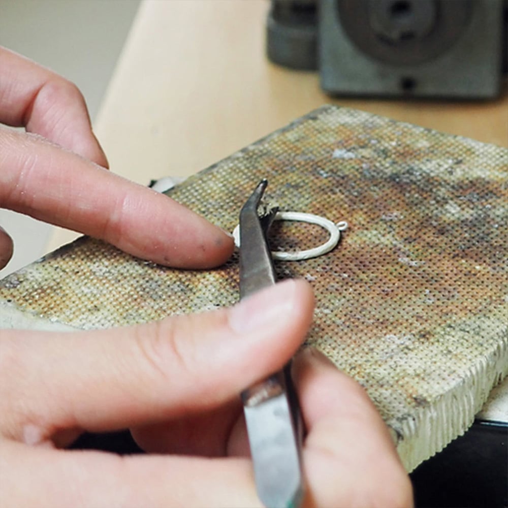 Stduent working on a loop necklace at Alex Monroe Jewellery school class