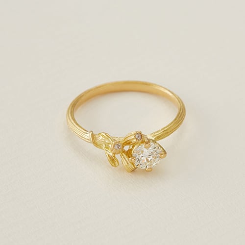 paper shot of solid yellow gold Asymmetric Diamond Kissing Seed Ring by Alex Monroe Jewellery