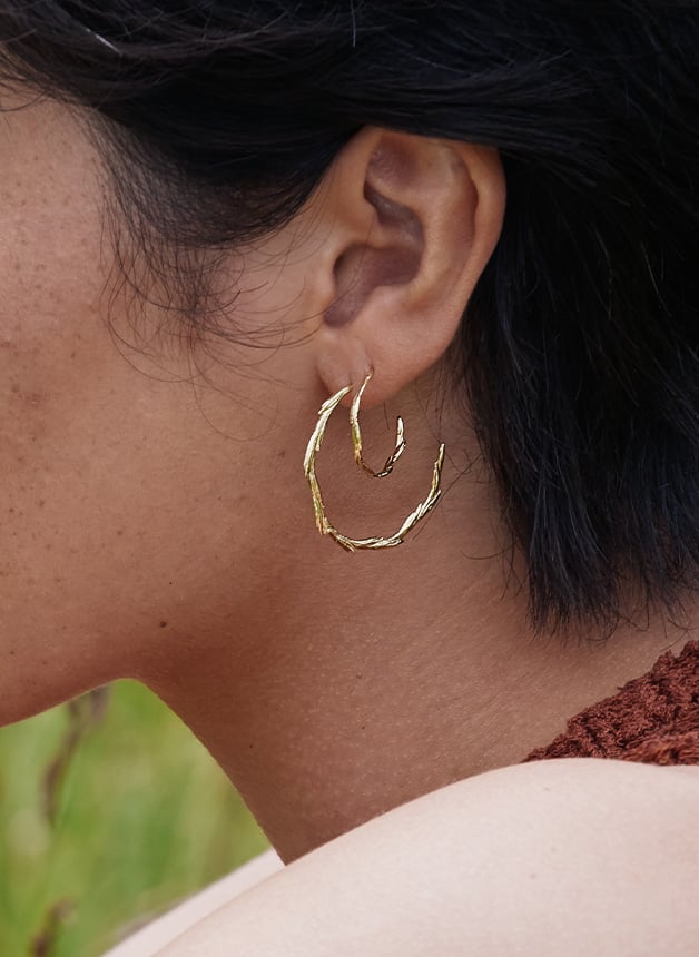 Close up Model wearing Alex Monroe's New Fine Collection Golden Harvest Fine and Large Wild Grass Hoop Earrings