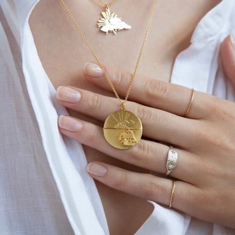 Model wears Sail into the Sunset Folding Disc Necklace