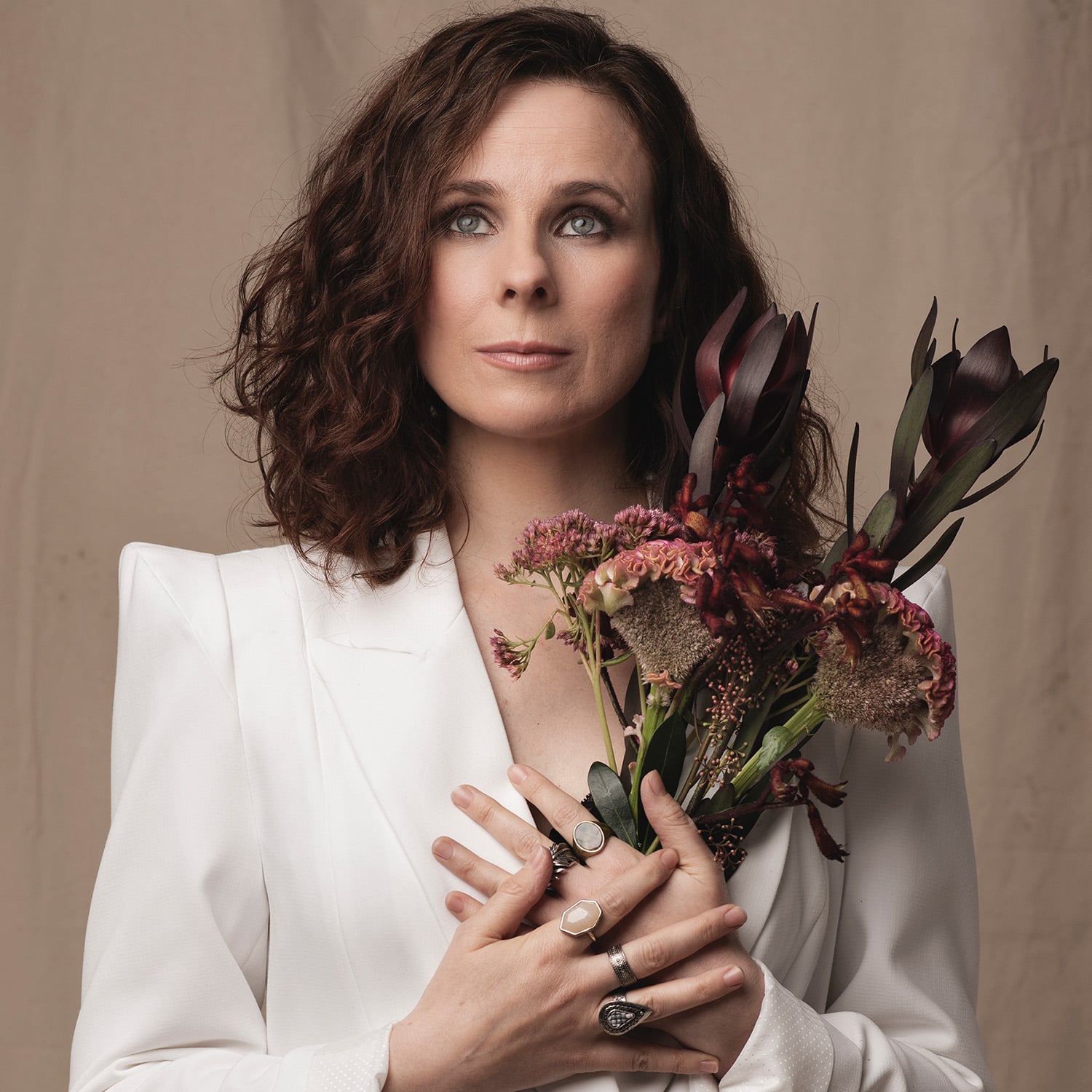 Profile photo of Cariad Lloyd wearing a white top holding a bunch of flowers