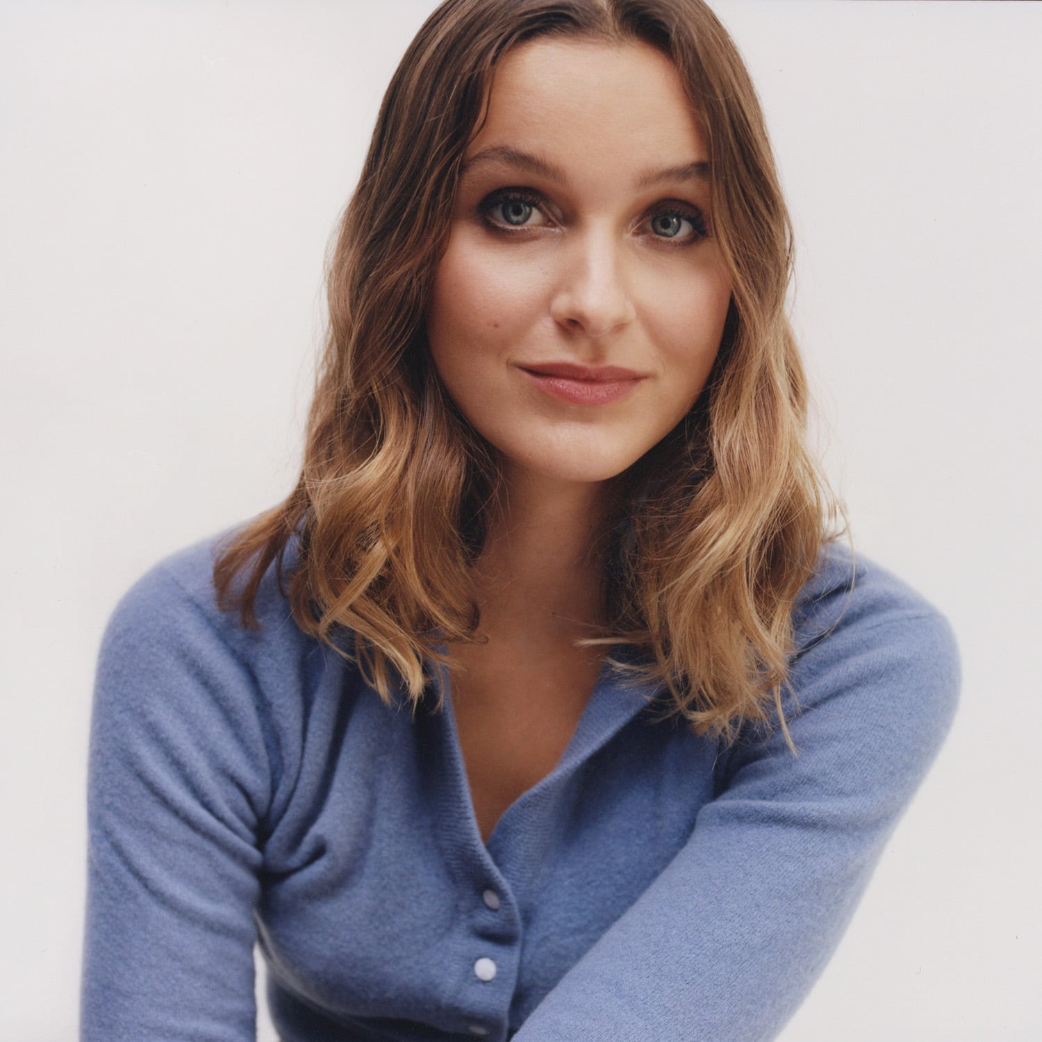 Profile photo of Rosie Viva wearing a blue jumper for Alex Monroe's Podcast