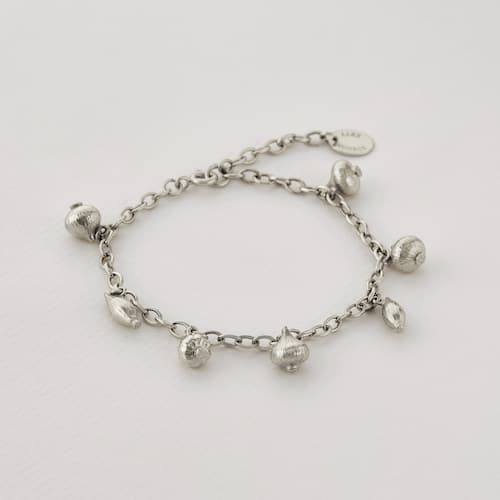 paper shot of silver Know Your Onions Charm Bracelet by Alex Monroe Jewellery