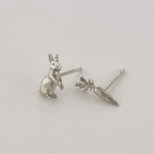 paper shot of silver plated Rabbit & Carrot Asymmetric Earrings by Alex Monroe Jewellery