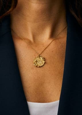 RNLI x Alex Monroe Gold Plated Coastal Scene Necklace styled with navy blazer and white top.