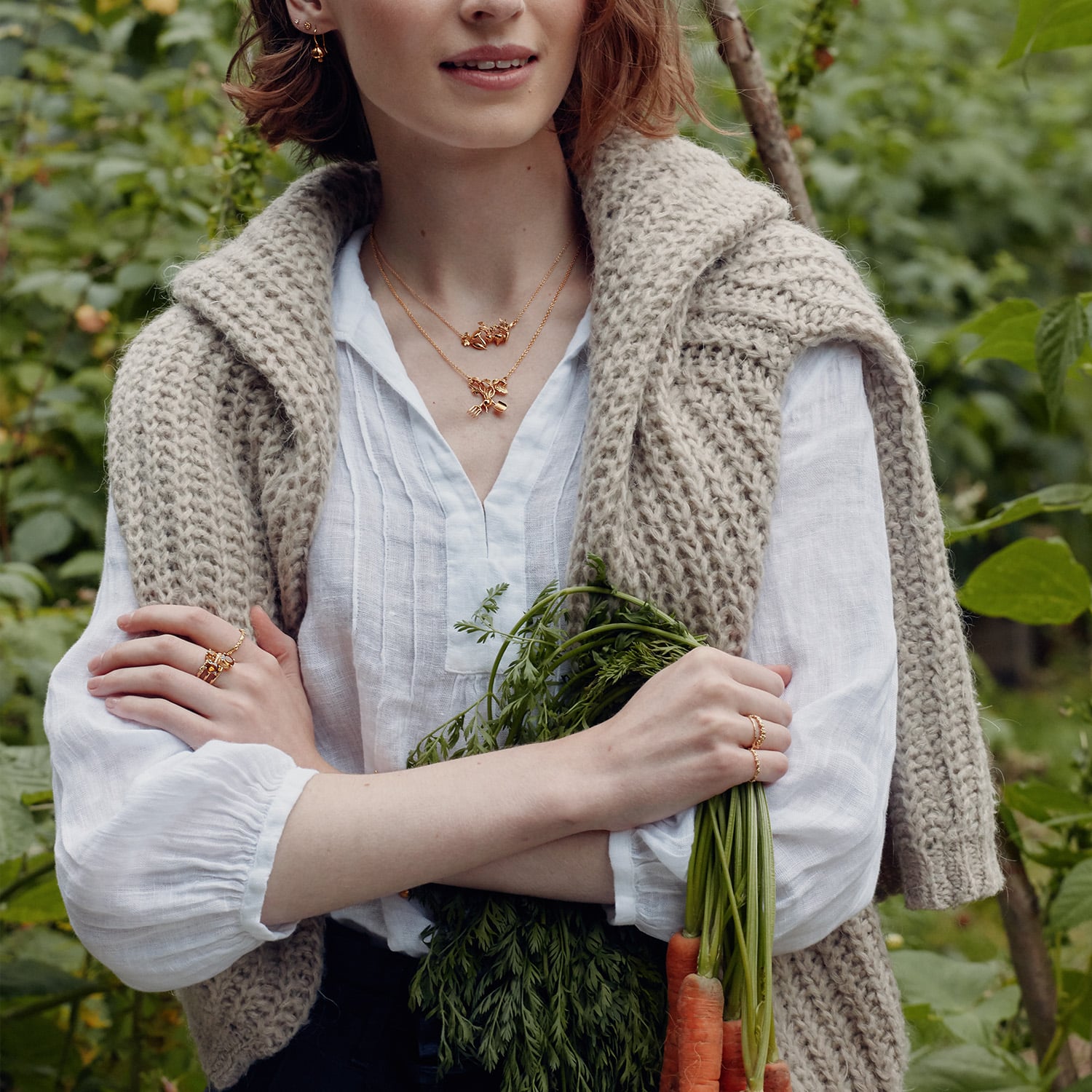 Model wearing the Sail into the Sunset Folding Disc Necklace and Rays of Hope Necklace by Alex Monroe Jewellery