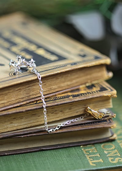 Doctor Who ear cuff placed on a vintage book