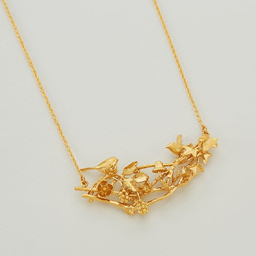 paper shot of gold plated Winter Woodland Treetop In-Line Necklace by Alex Monroe Jewellery
