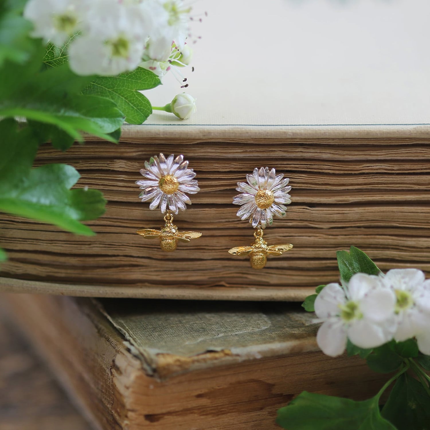 Lifestyle shot of the Daisy Stud Earrings with Teeny Tiny Bee Drops by Alex Monroe Jewellery