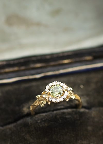 Limited Edition green sapphire halo ring in a vintage ring box