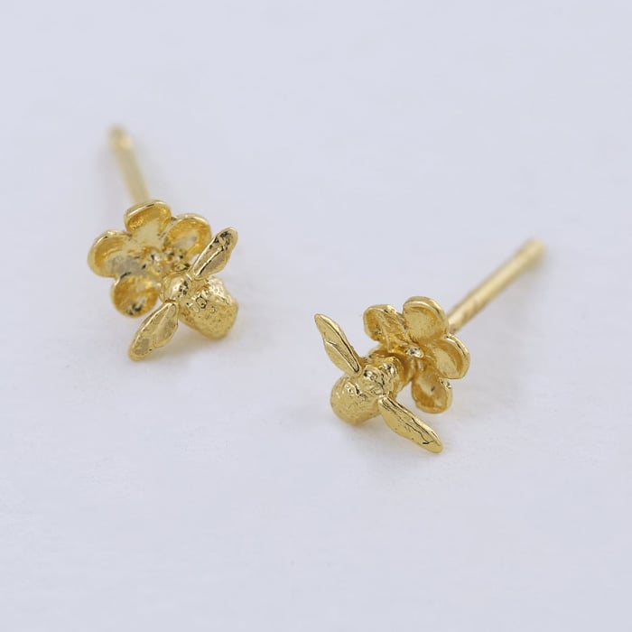 Paper shot of gold plated Forget Me Not Stud Earrings with Itsy Bitsy Bee by Alex Monroe Jewellery