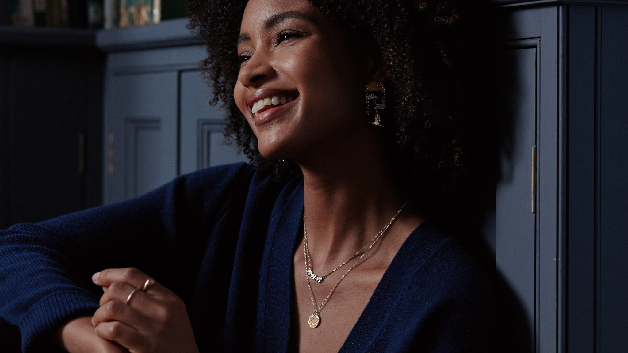 Model wearing 3 layered necklaces - Alex Monroe's Rays of Hope Necklace, Hummingbird Necklace and Dandelion Fluff Necklace