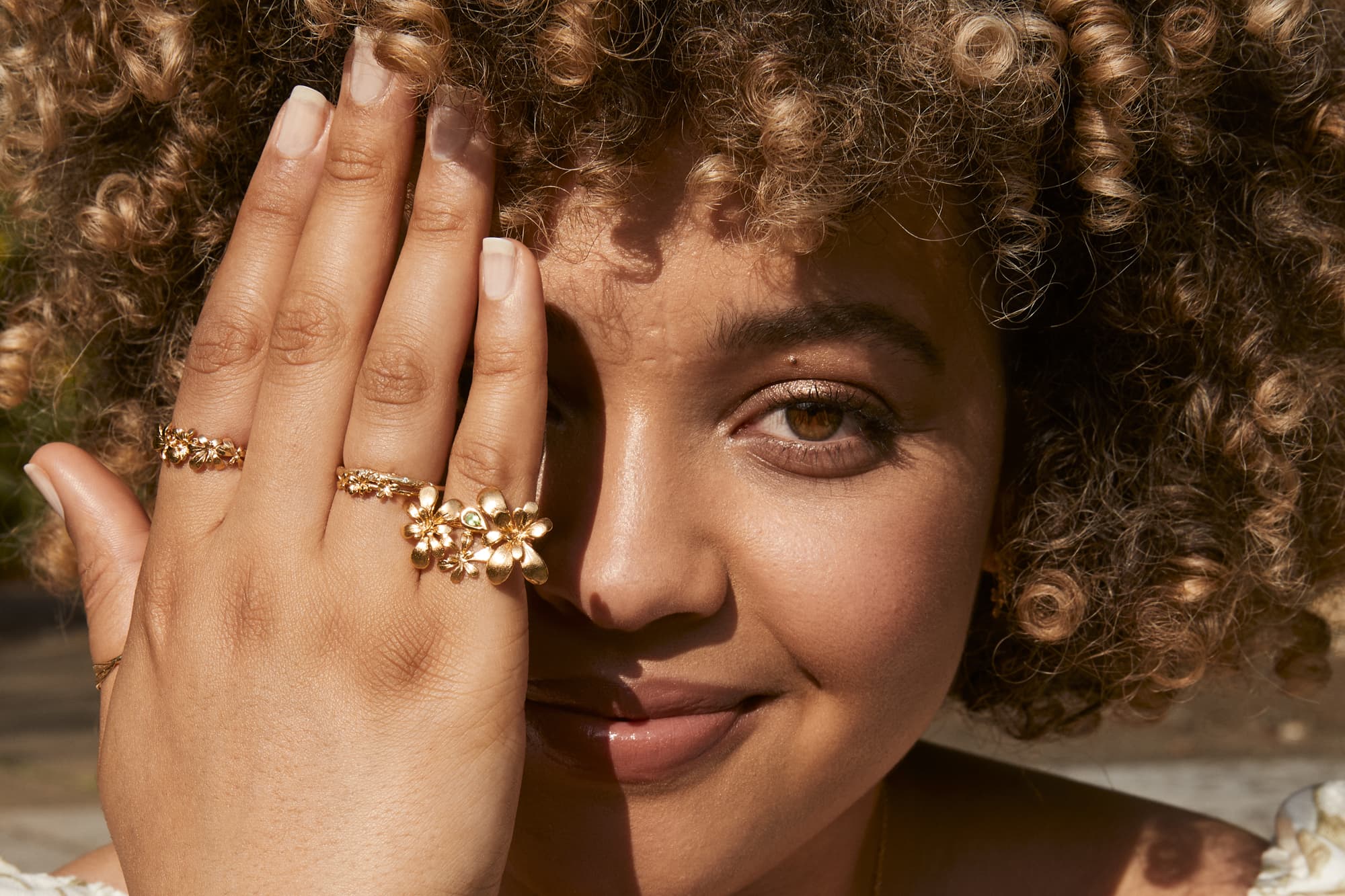 Model wears Humble Beginnings silver 22ct fairmined gold plate rings Clustered Rosette Prosper Ring with Teardrop Peridot