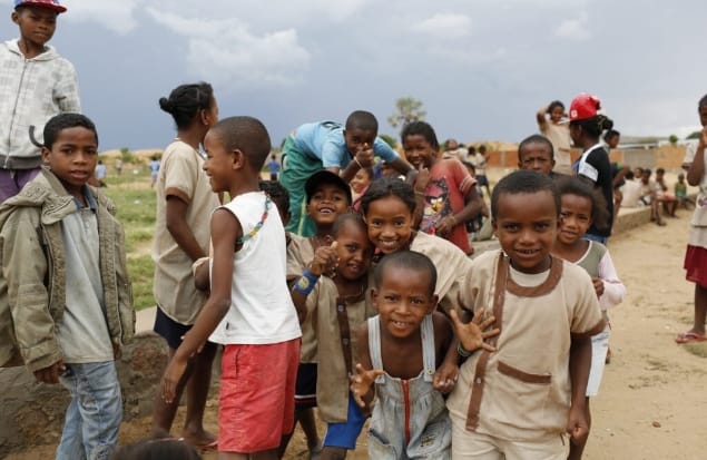 Children gathered and smiling at the camera.