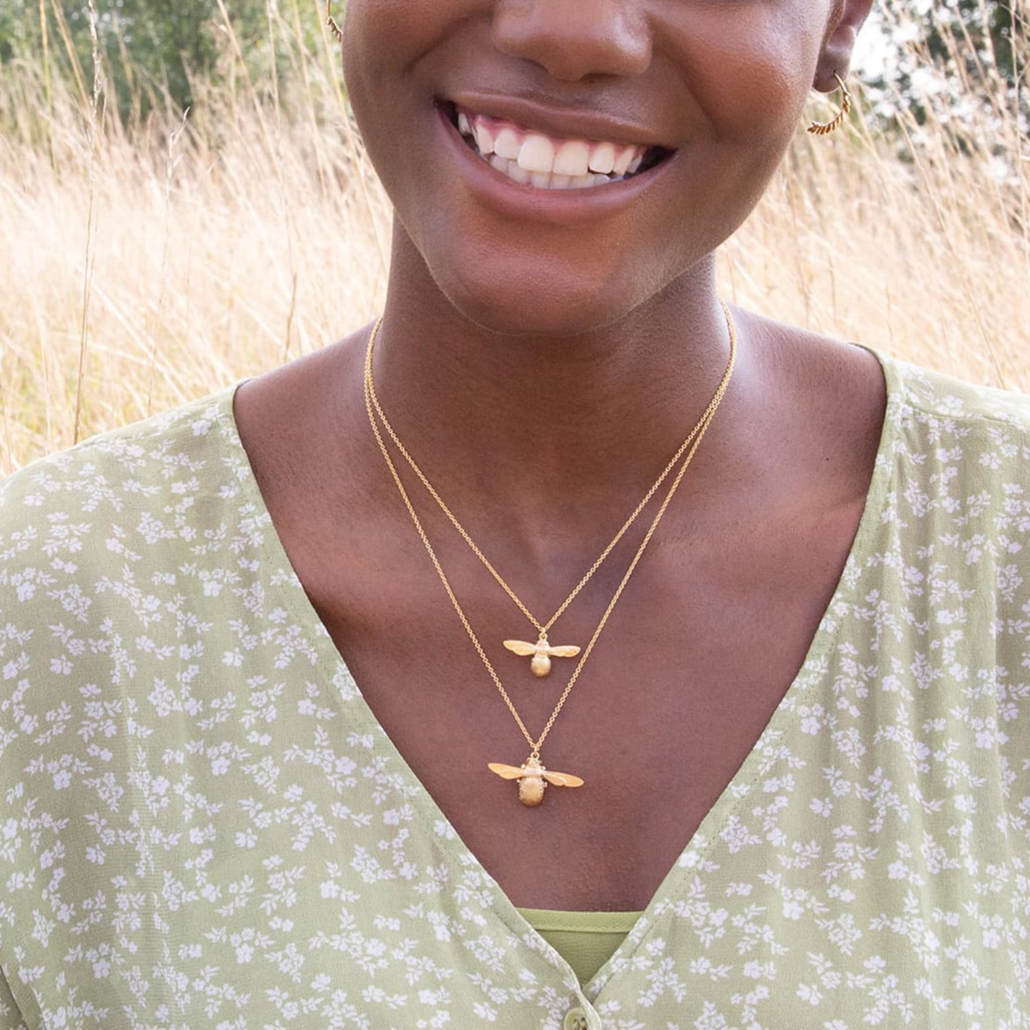 Model wearing the iconic Alex Monroe bumble and baby bee necklaces layered together