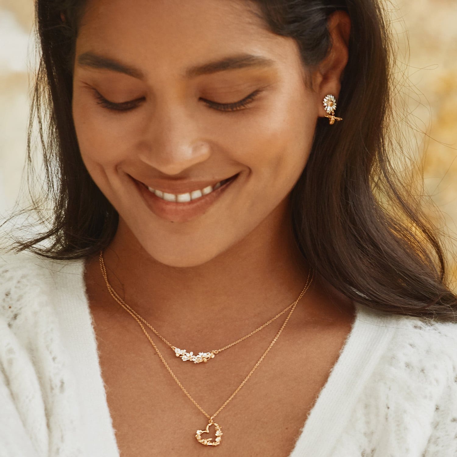  model wearing Alex Monroe gold plated Floral Heart Necklace with Itsy Bitsy Bee