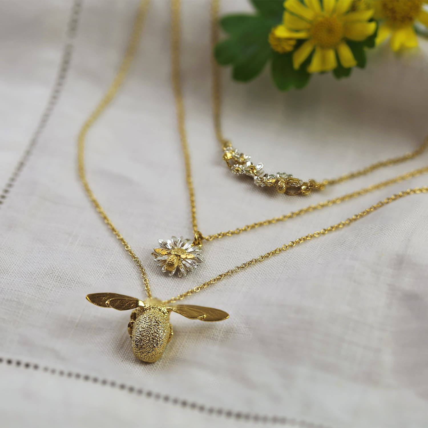 Alex Monroe's iconic original gold plated bumblebee necklace and a garden gathering necklaces